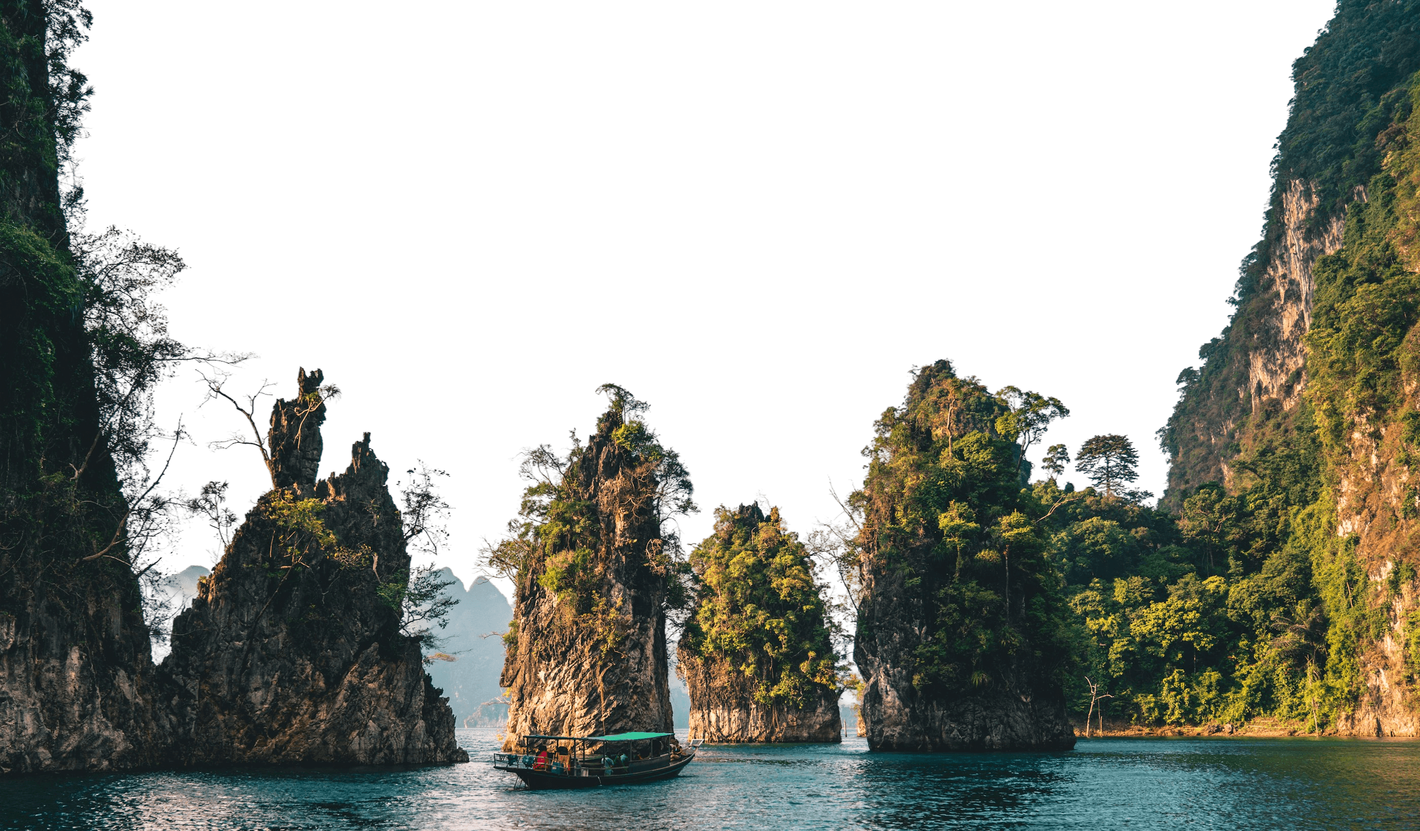 Dramatic green limestone mountains surrounding a river valley