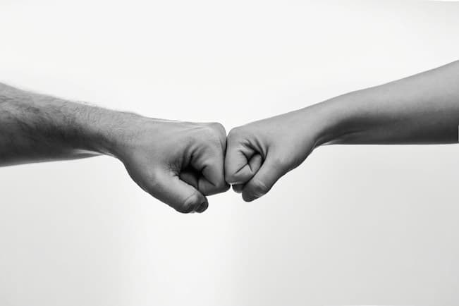 Two travelers joining hands